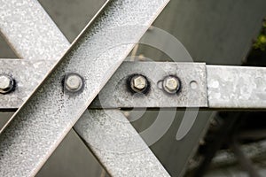 Steel gray metal bars with bolts and washers