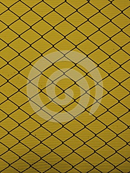 Steel grid on a yellow background
