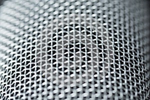 Steel grille background. Close-up shot of microphone.