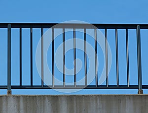 Steel guard rail with pickets and posts on highway with blue sky