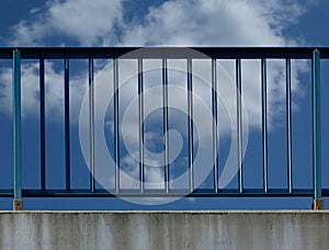 Steel guard rail with vertical pickets and posts along highway