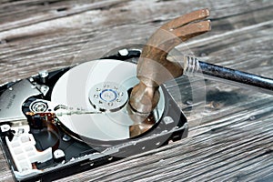 A steel hammer on HDD platters and spindle motor, hard disk drive disassembled damaged components, computer maintenance, recovery