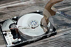 A steel hammer on HDD platters and spindle motor, hard disk drive disassembled damaged components, computer maintenance, recovery