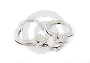 Steel handcuffs on a green background