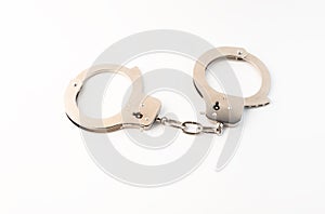 Steel handcuffs on a green background