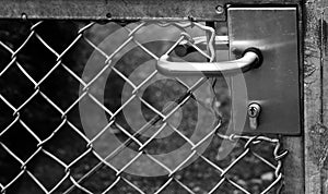 Steel handlebars of a closed door black and white photo