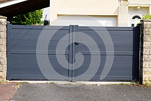 Steel high grey metal gate fence on design gray modern suburb house street