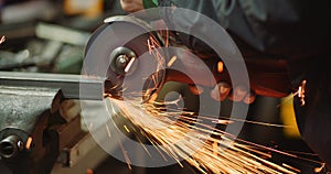 Steel Industry - Man using Angle Grinder Grinding Metal Object.