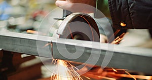 Steel Industry - Man using Angle Grinder Grinding Metal Object.