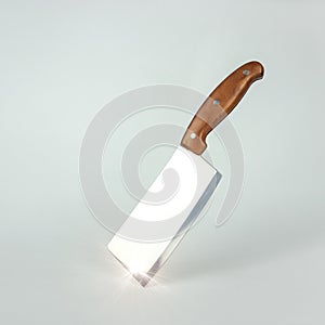Steel kitchen knive on white background. Kitchen knife balanced on its end