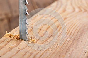 Steel knife of carpentry jigsaws. Tools in a home workshop