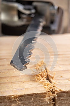 Steel knife of carpentry jigsaws. Tools in a home workshop