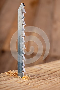 Steel knife of carpentry jigsaws. Tools in a home workshop