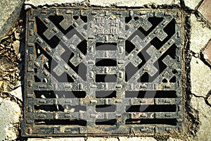 Steel manhole cover and surrounding cement brick