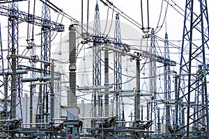 Steel masts of high voltage power lines at the plant. Electrical substation, power converter, high voltage electric