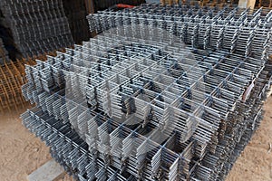 Steel mesh for construction Steel Rebars for reinforced concrete. Steel reinforcement bar texture in construction site