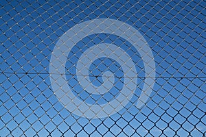 Steel mesh wire fence with blue sky under blue sky