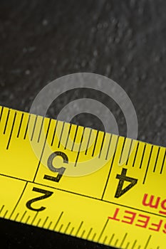 steel metal measuring tape yellow color macro in a table