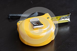 steel metal measuring tape yelow color macro in a table