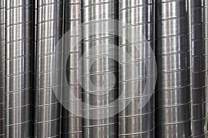 Steel or metal round pipes as industrial background, vertical pipeline ventilation tubes