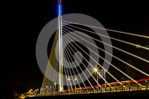 steel modern bridge against night sky. Abstract pattern by bridge wire, Fragment of a modern cable stayed bridge on the