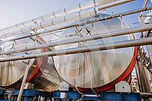 Steel modern cisterns for wine production on plant territory. Large tanks