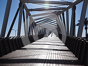 Steel pedestrian bridge over a busy street