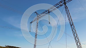 Steel pillar with high voltage electric power lines delivering electrical energy through cable wires on long distance