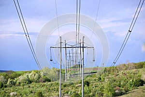 Steel pillar with high voltage electric power lines delivering electrical energy through cable wires on long distance