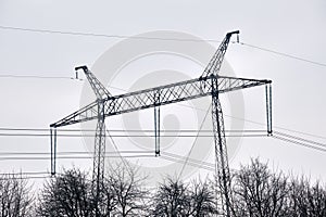 Steel pillar with high voltage electric power lines delivering electrical energy through cable wires on long distance