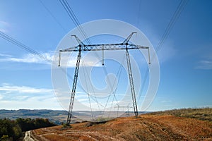 Steel pillar with high voltage electric power lines delivering electrical energy through cable wires on long distance