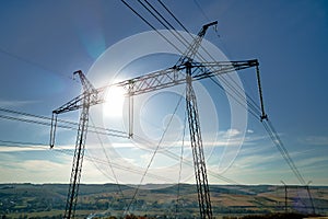 Steel pillar with high voltage electric power lines delivering electrical energy through cable wires on long distance