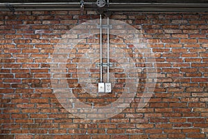 Steel pipe electric wire and plug on vintage brick wall backgrou
