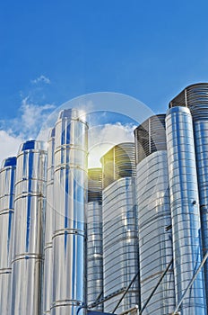 Steel pipes and pipelines against blue sky. Abstract blue background. Modern industrial station