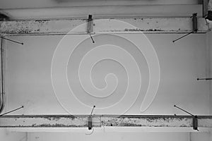 Steel pipes is Rust deliver wires hanging from the ceiling. Architecture geometric. Details of building structure. Black and white