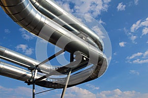 Steel pipes under blue sky in industrial zone