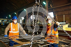 Steel Plant Workers Using Lifting Beam