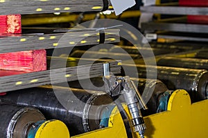 Steel plates stacked and pneumatic tensioner holding steel strap photo