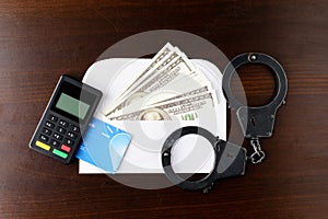 Steel police handcuffs, dollars money, payment device and bank c