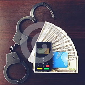 Steel police handcuffs, dollars money, payment device and bank c