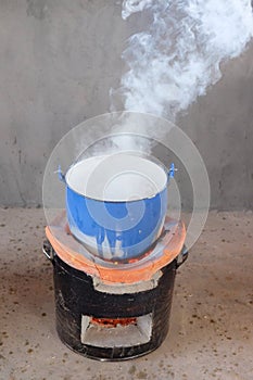 Steel pot on clay stove in Thai kitchen