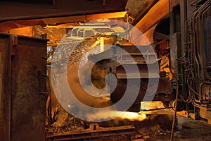 Steel production in electric furnaces. Sparks of molten steel. Electric arc furnace shop . Metallurgical production, heavy