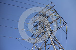 Steel pylon for high voltage power lines against blue sky