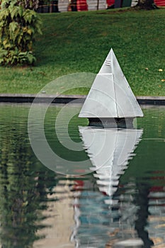 Steel Pyramid sculpture in the park`s pool near Petronas twin towers in Kuala Lumpur, Malaysia