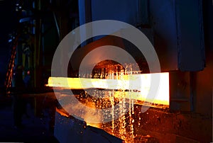 Steel quenching at high temperature in industrial furnace at the workshop of a forge plant. Process of cooling, heat treatmen.