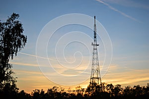 Steel radio tower at sunset