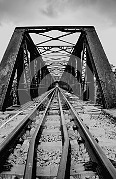 Steel railway bridge in black and white.