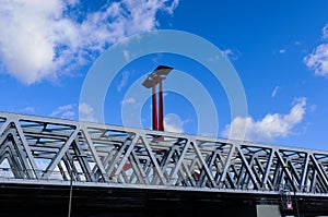 Steel railway bridge closeup in perspective view. red steel post with solar panel