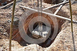 Steel-reinforced concrete columns and block concrete framework in the pit of footing foundation.