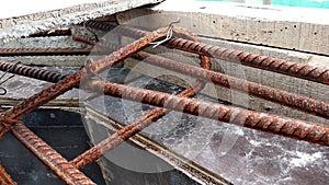 Steel reinforcement bars for reinforced concrete construction have started to rust after being exposed to weather and water vapor.